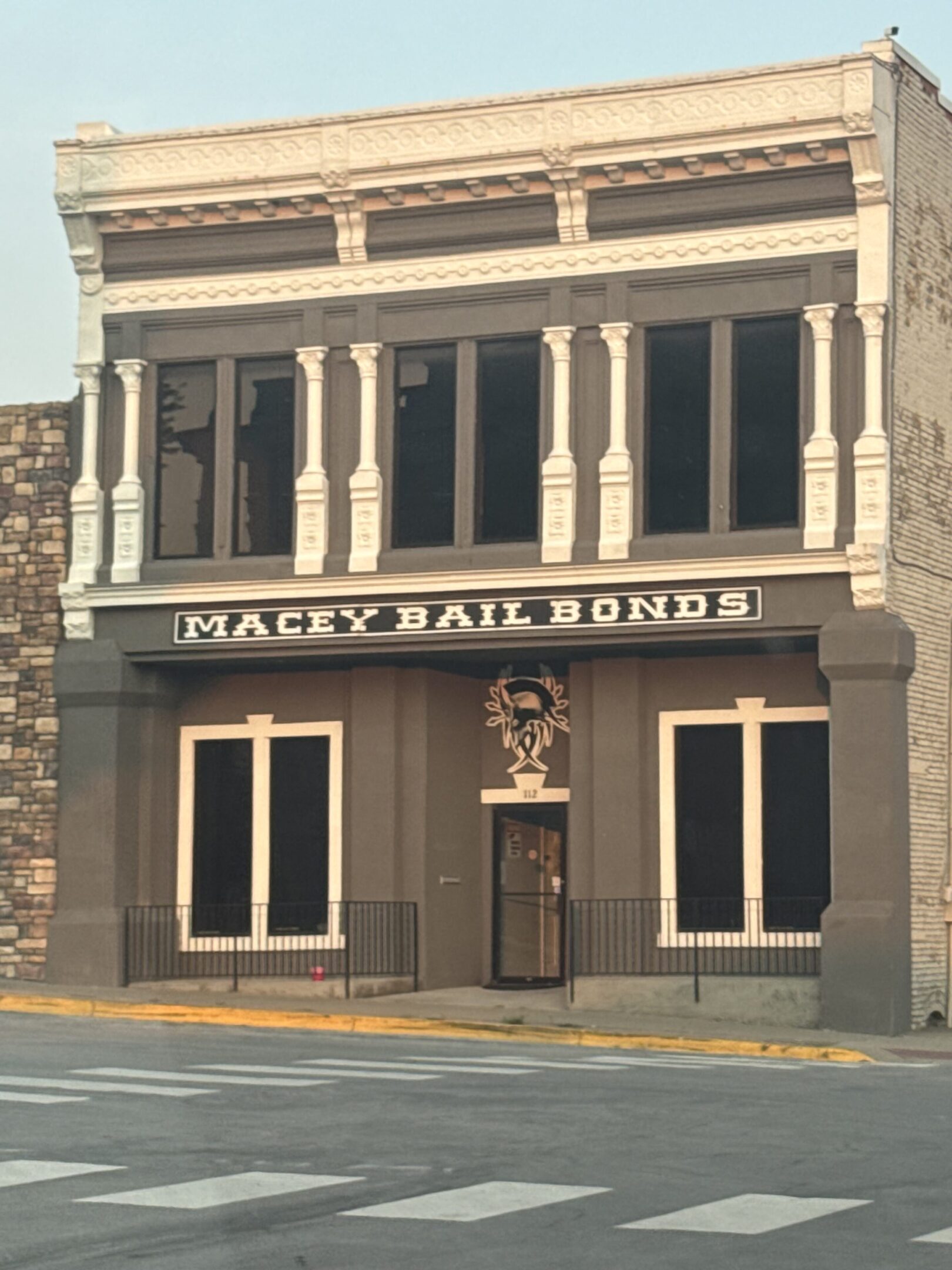 Facade of a vintage building with 'Macey Bail Bonds' signage.