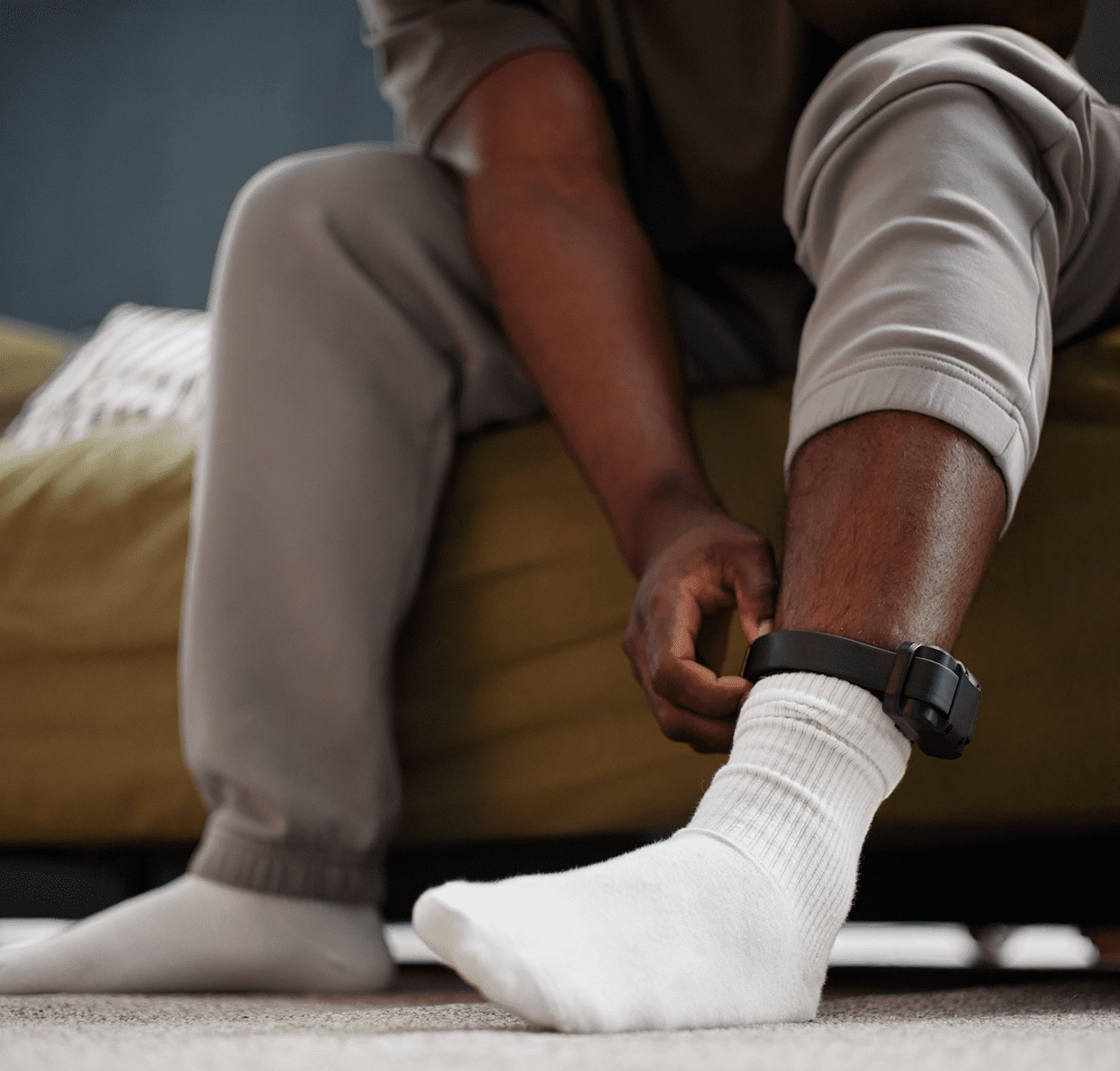Close-up of ankle monitor and white socks